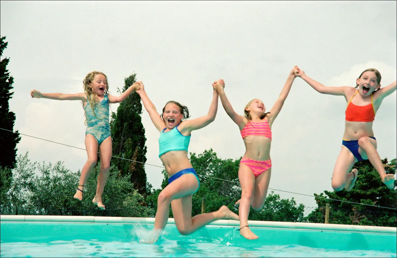 Família feliz aproveitando a piscina segura com crianças